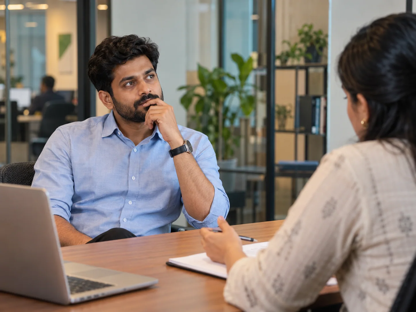 An Indian millennial man pauses to think before answering an unexpected interview question